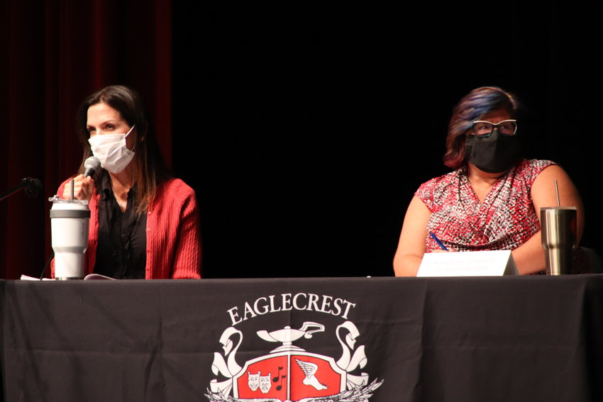 Jen Gibbons, left, and incumbent school board member Kelly Bates sit on stage Sept. 21 at a Cherry Creek school board candidates' forum at Eaglecrest High School in the east Centennial area.